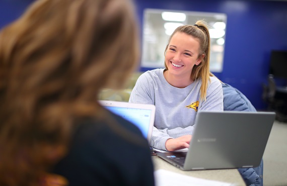 students work together in the library