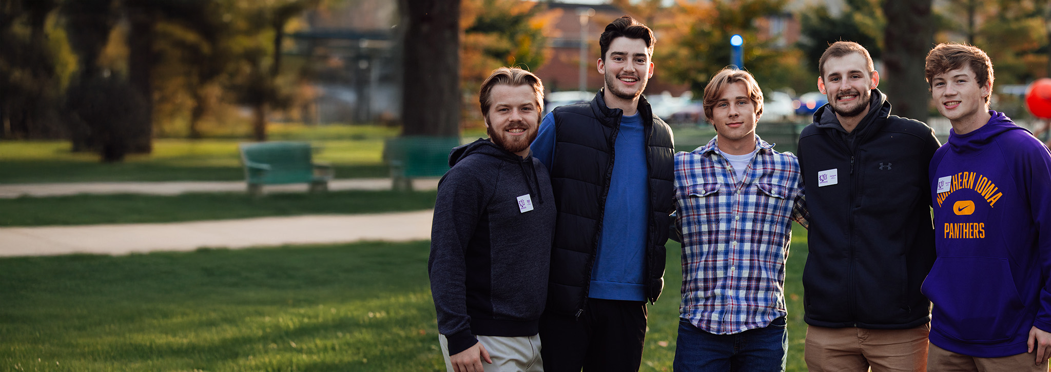 Group of business students standing together, smiling, as part of a student organization.