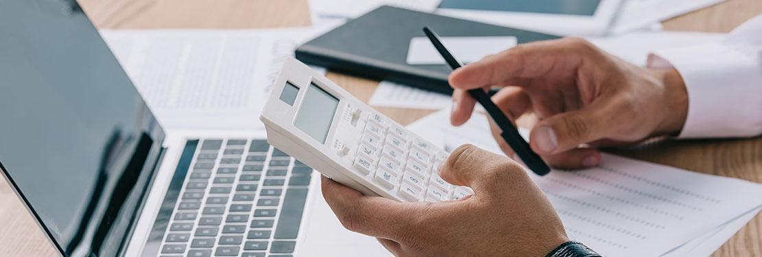Accountant holding calculator