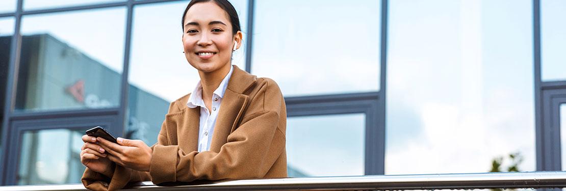 Real estate sales professional in front of building